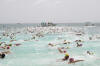 THE MASSIVE CROWD OF SWIMMERS SPREADS OUT